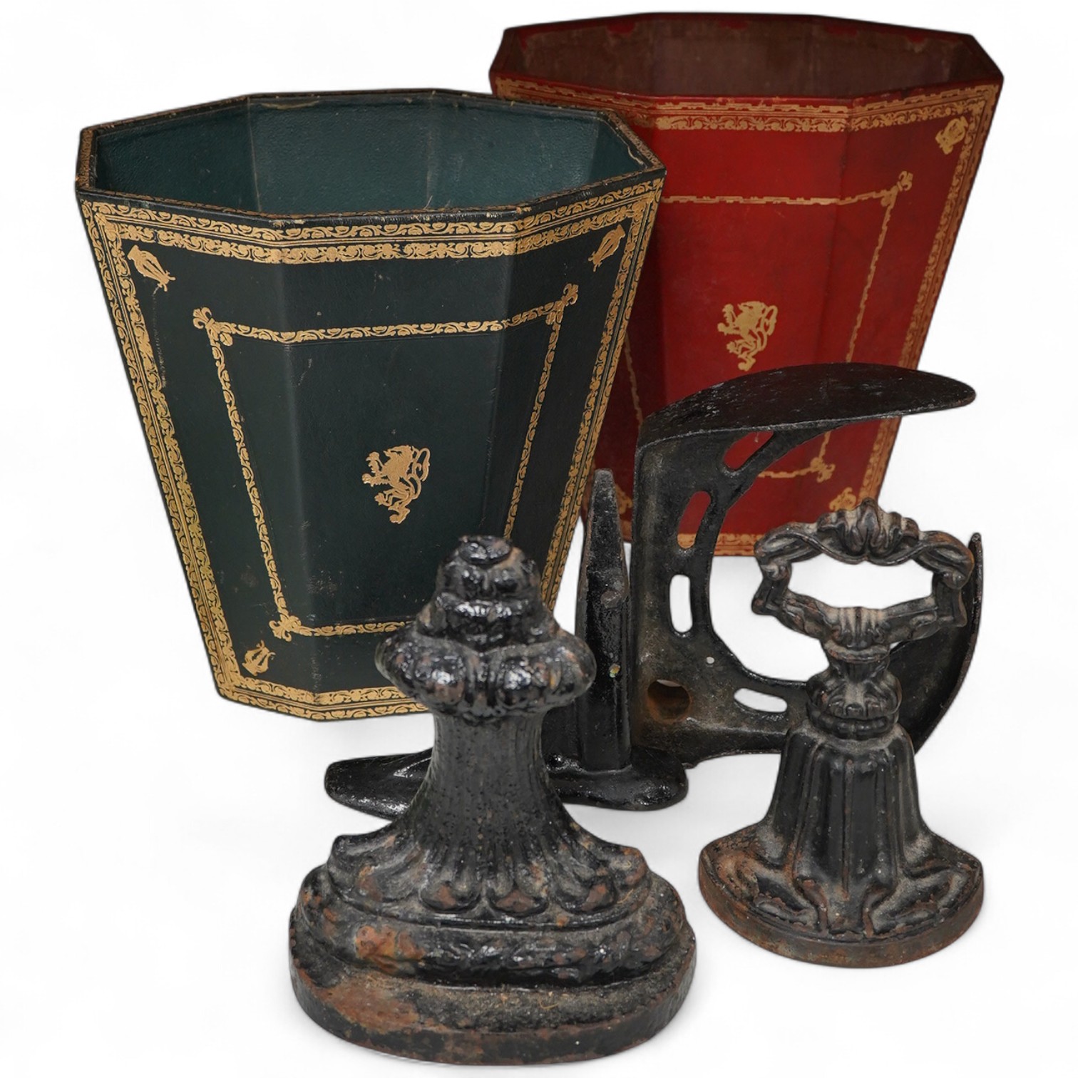 Two Italian gilt tooled leather waste paper baskets together with two Victorian cast iron doorstops and two boot scrapers, largest 29cm high
